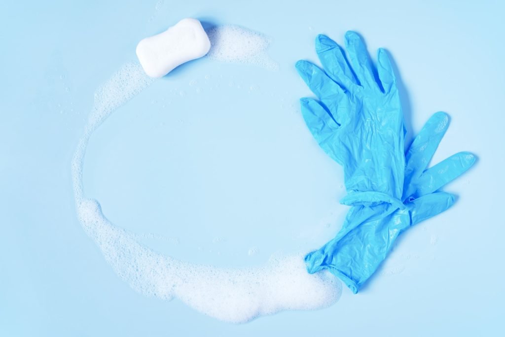 Blue Background with Soap, Foam and Rubber Gloves