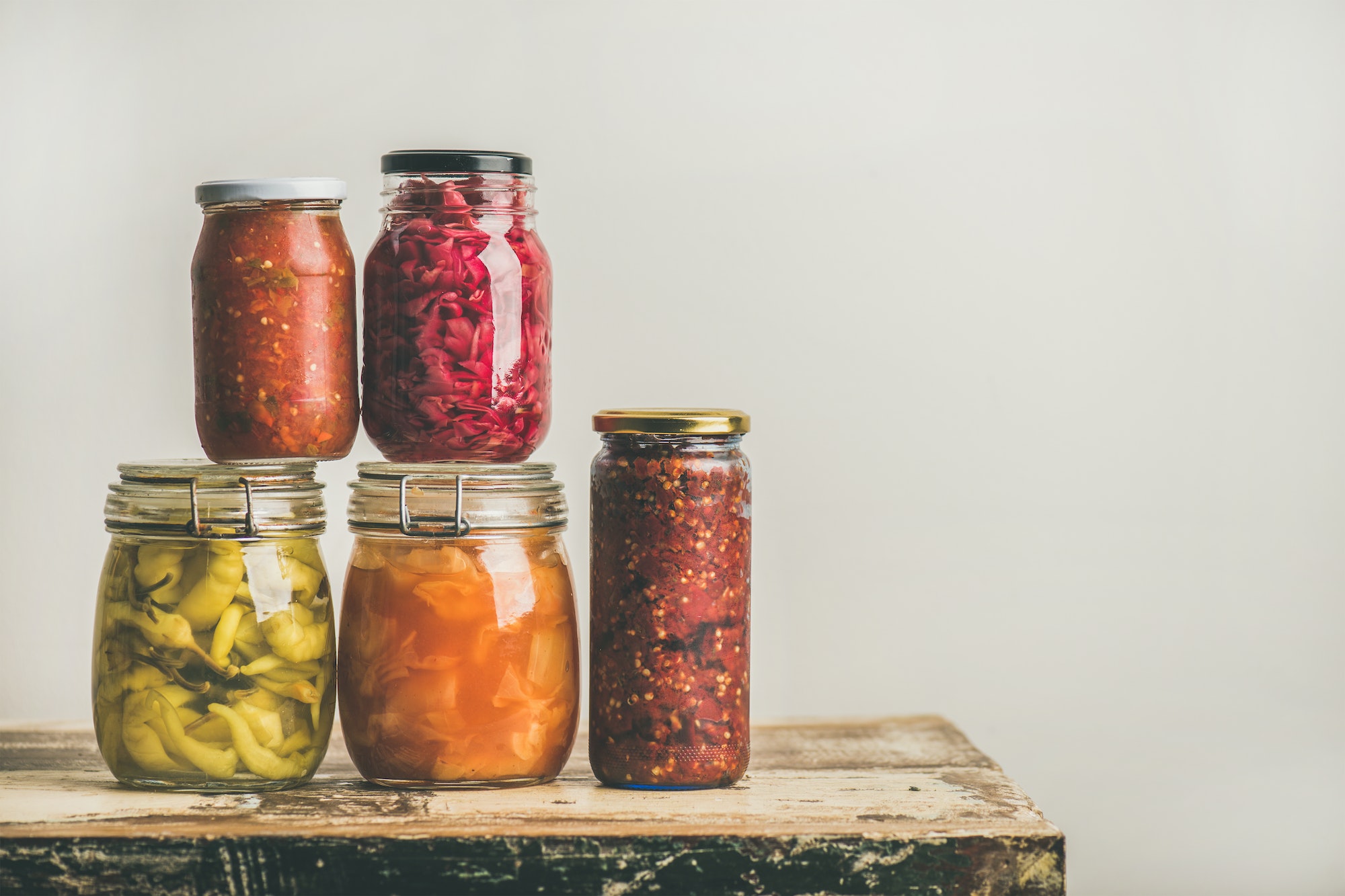 Autumn seasonal pickled or fermented vegetables in jars, copy space